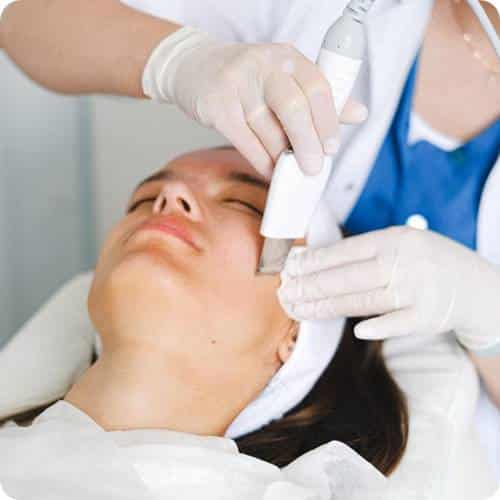 a woman receiving a facial treatment