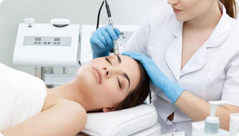 a woman getting a facial treatment