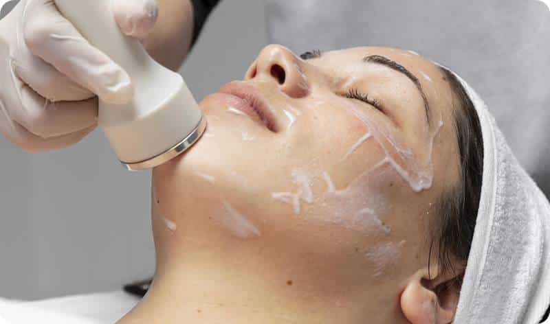 a woman receiving a facial treatment